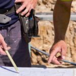 Surveyors reviewing site plans on a San Diego property to address failed perc test challenges