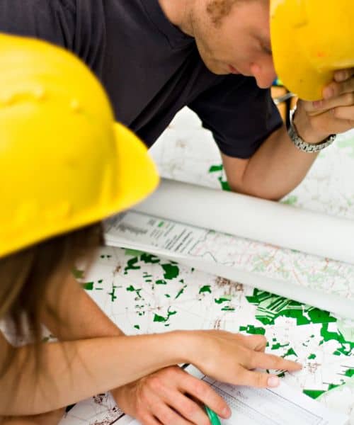 Engineers reviewing elevation survey data and preparing a flood elevation certificate