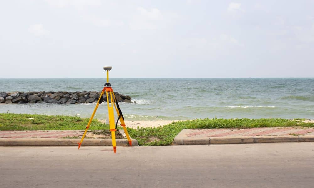 Survey equipment used during an elevation survey to measure coastal property height near the shoreline