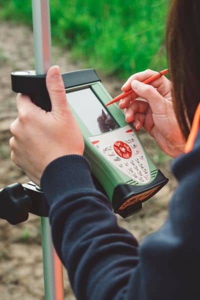 Surveyor recording elevation measurements using a field data collector during an elevation survey